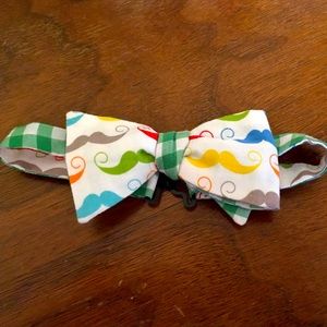 Boys colorful bow tie with mustaches.